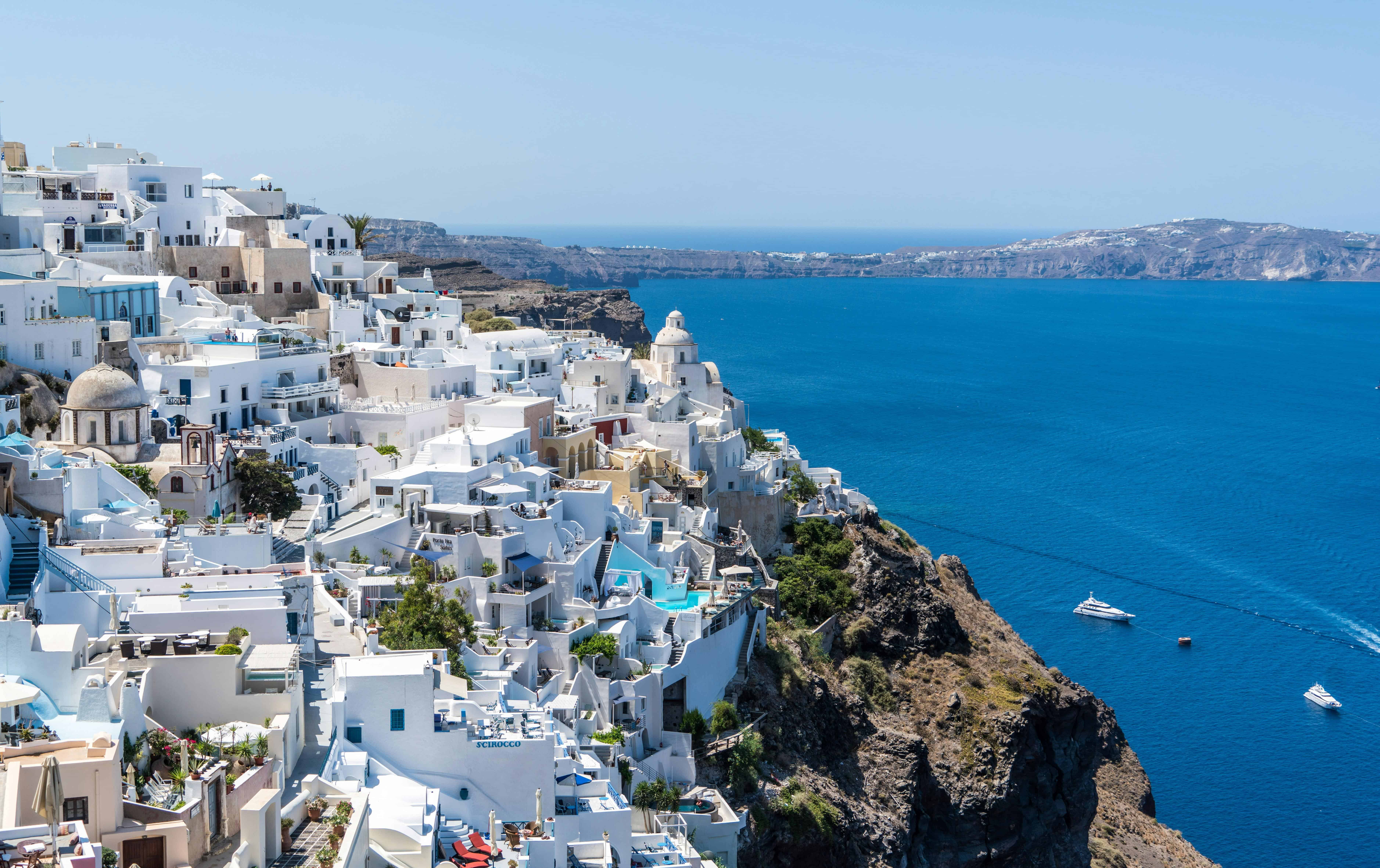 Santorini cliffside village with white buildings overlooking the Aegean Sea.