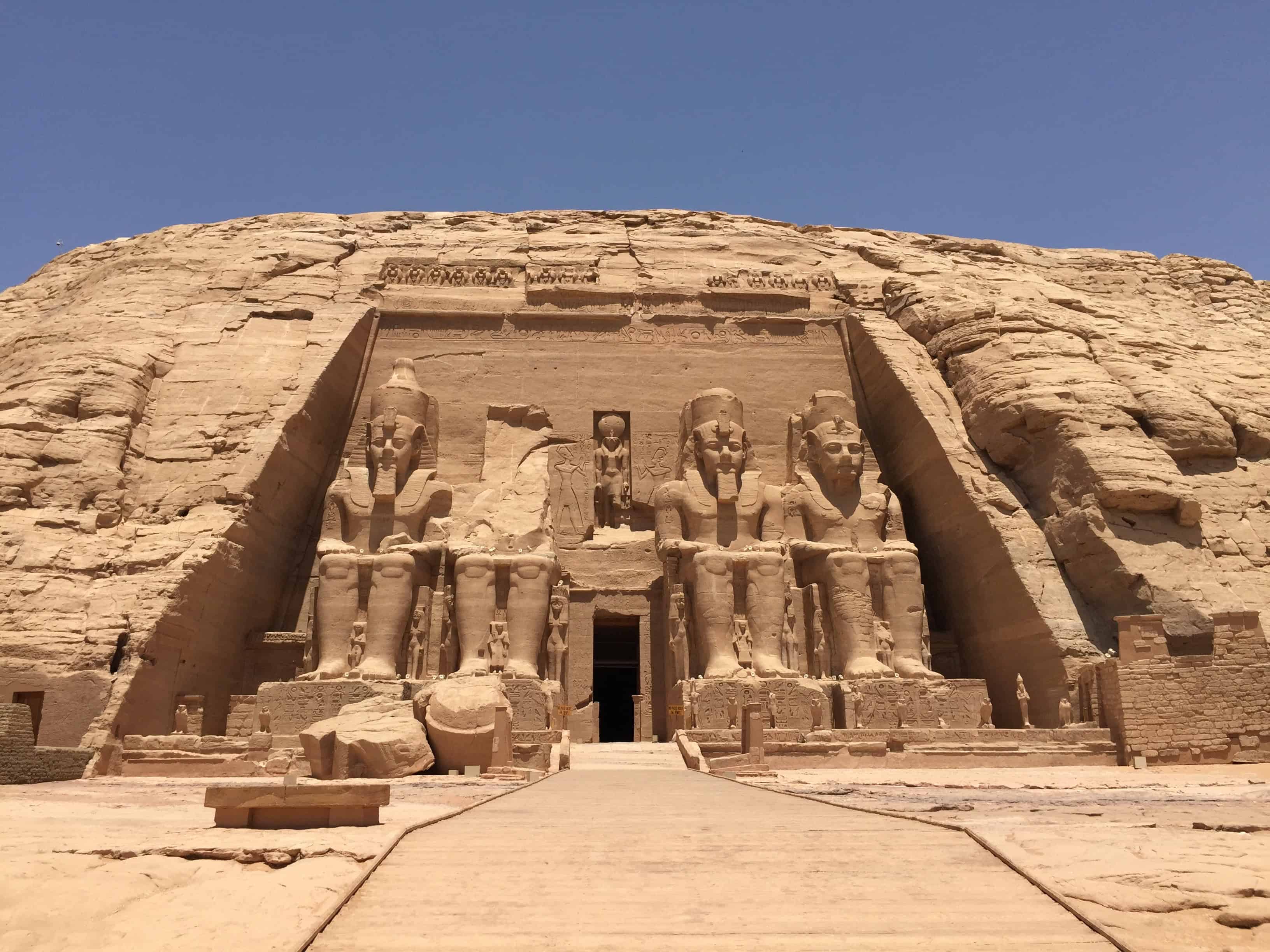 Ancient Egyptian temple with colossal statues at Giza plateau, showcasing historic architecture and.